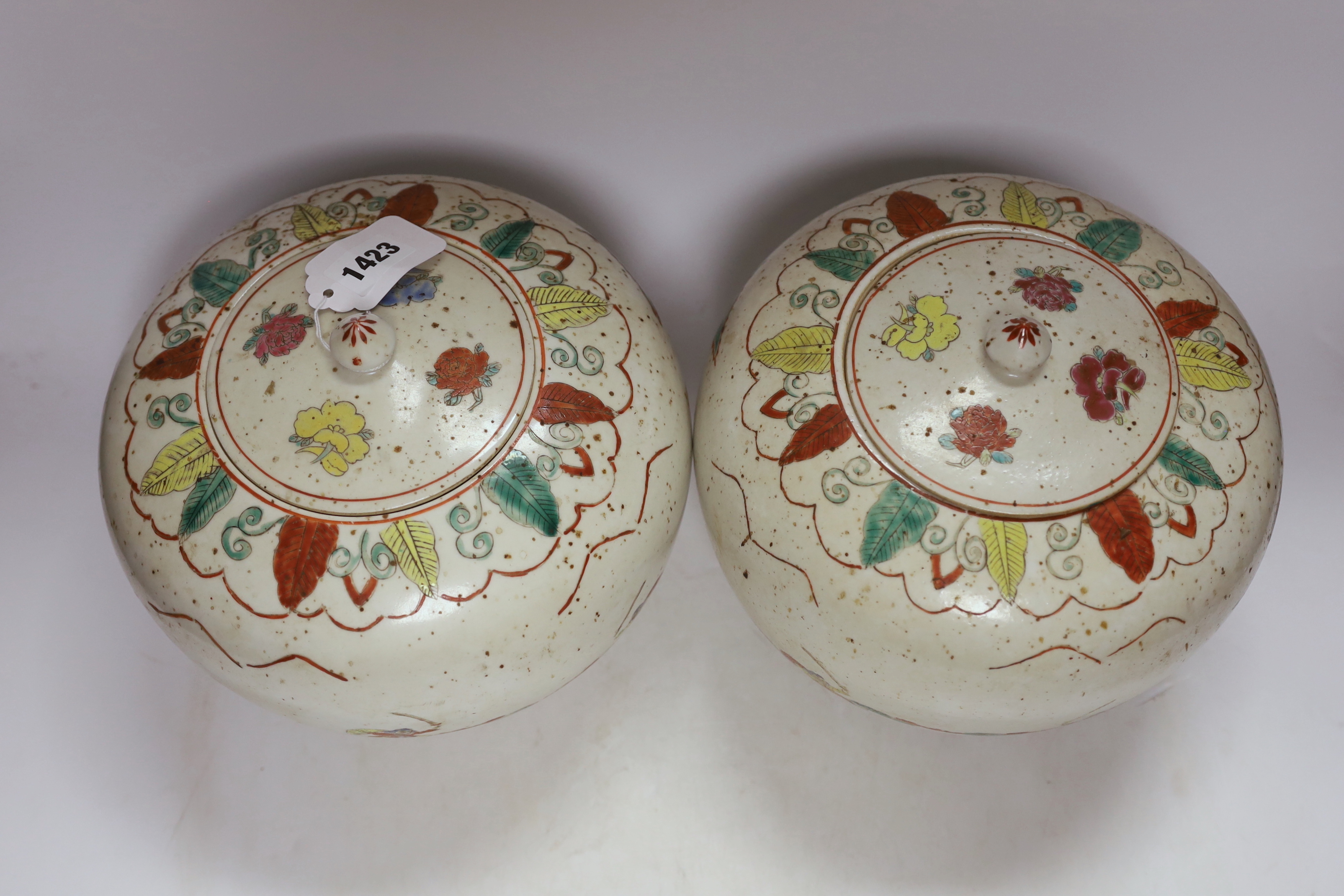 A pair of Chinese famille rose jars and covers